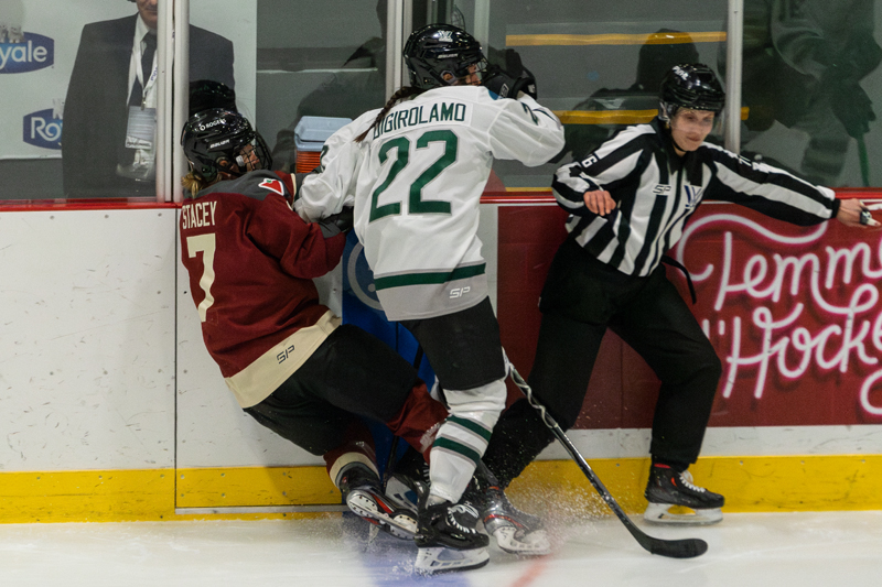 Boston's Jessica Digirolamo lays the body on Montreal's Laura Stacey. | photo: Kieron Yates / Modern Free Press