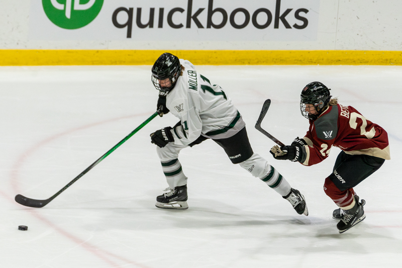 Boston's Alina Müller races off with the puck with Montreal's Ann-Sophie Bettez in pursuit. | photo: Kieron Yates / Modern Free Press
