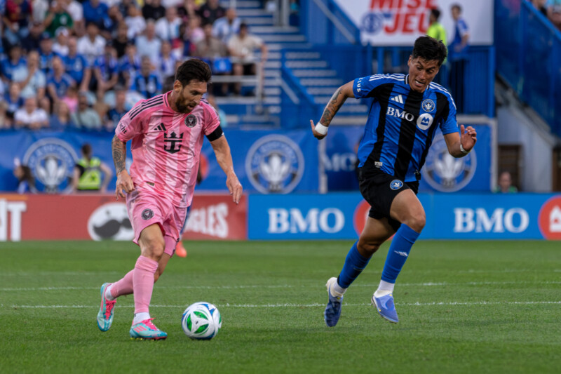 Lionel Messi of Inter MIami is watched by Luca Petrusso of CF Montreal at Stade Saputo on July 5, 2025.