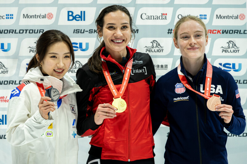 Canada's Courtney Sarault (Gold0, South Korea's Kim Gilli (Silver) and Corrine Stoddard recieve their medals at the ISU Short Track World Tour at Maurice Richard Arena in Montreal, on October 12, 2025. Photo: Kieron Yates